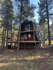 a tree house in the middle of a forest at Cozy Alpine A-Frame in Flagstaff