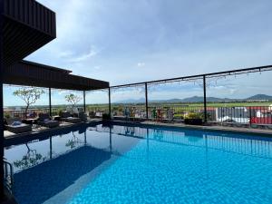 a swimming pool on top of a building at Paragon Noi bai Hotel & Pool in Thach Loi