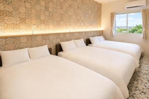 two white beds in a room with a window at Small Resort 志摩 in Shima
