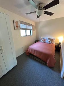 a bedroom with a bed and a ceiling fan at Cozy Alpine A-Frame in Flagstaff