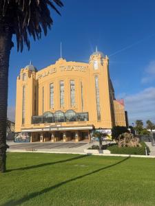 a large building with a clock on the side of it at St Kilda Accommodation in Melbourne