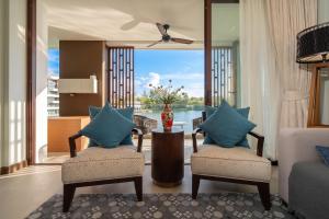 a living room with two chairs and a table at Laguna luxury apartment - Bang Tao - lake view in Bang Tao Beach