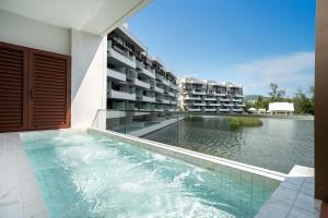 a swimming pool in the middle of a building at Laguna luxury apartment - Bang Tao - lake view in Bang Tao Beach