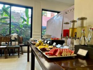 a buffet line with fruit on a table in a restaurant at Paragon Noi bai Hotel & Pool in Thach Loi