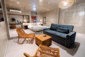 a living room with a couch and a bed at Cebu R Resort Tabuelan in Tabuelan