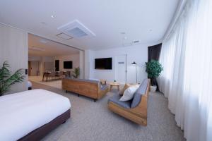 a hotel room with a bed and a living room at Olympic Inn Azabu in Tokyo