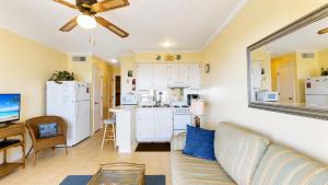a living room with a couch and a kitchen at Oceanfront 1BR • Updated Balcony • Cherry Grove • Sea Cabin 206-A in Myrtle Beach +13 photos