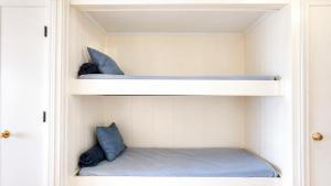 two bunk beds with blue pillows in a room at Oceanfront 1BR • Updated Balcony • Cherry Grove • Sea Cabin 206-A in Myrtle Beach