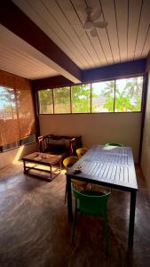 a living room with a wooden table and chairs at One bedroom apartment Hin Kong in Ko Phangan