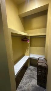 a walk in closet with empty shelves and a chair at One bedroom apartment Hin Kong in Ko Phangan