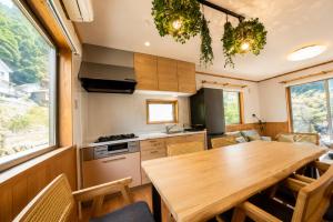 a kitchen and dining room with a wooden table at BLUEBAY TERRACE okutama in Okutama +28 photos