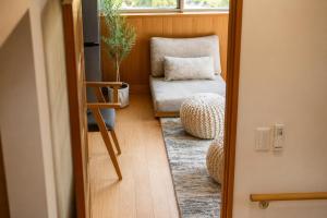 a room with a chair and a window and a chair with a plant at BLUEBAY TERRACE okutama in Okutama