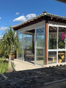 a conservatory with glass doors and a palm tree at Finca Villa Rosita 26 in Copacabana +18 photos