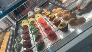 a display case with a bunch of donuts on display at Il Casale in Marano Marchesato