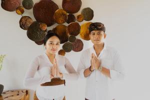 a man and a woman standing in front of a wall at Bamboo Layang Ubud in Ubud +100 photos