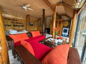 a living room with red pillows and a couch at Sapawine Homestay in Sapa