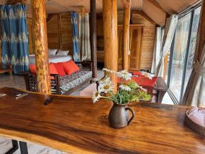 a vase with flowers on a table in a room at Sapawine Homestay in Sapa +46 photos