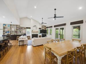 a large living room with a table and chairs at Woodbine Lodge in Marysville