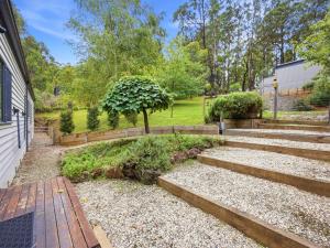 a garden with stairs next to a house at Woodbine Lodge in Marysville