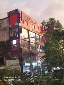 a building with neon signs on the side of it at Hotel The One Point, Uttara in Bāiljuri