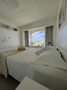 a bedroom with a large bed with a large window at Luxus Duplex 102m2 Vista Mar - Vilas do Atlântico in Lauro de Freitas +118 photos