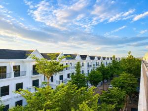 an image of a building with trees in the foreground at EcoCity Suites BMT in Buôn Enao