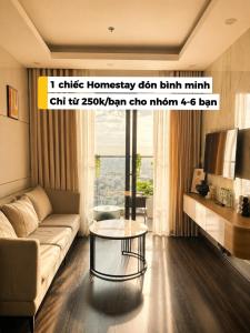 a living room with a couch and a table at HERE Stay in An Khê