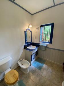 a bathroom with a toilet and a sink and a mirror at Sagala Boutique Hotel in Bandarawela +40 photos