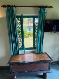 a room with a window with green curtains at Sagala Boutique Hotel in Bandarawela