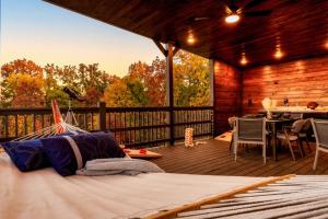 a room with a bed on a wooden deck at Open Skydeck with Spectacular View and Hot Tub in Sevierville +16 photos