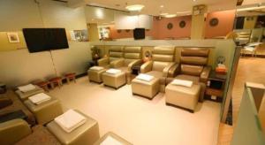 a living room with couches and a flat screen tv at Hong Thai Hotel in Macau