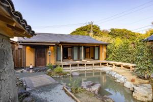 a house with a pond in front of it at Temple Stay KAN 観 in Yokosuka
