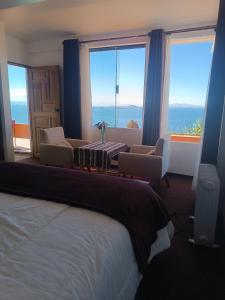 a hotel room with a bed and a view of the ocean at Sol y Luna in Comunidad Yumani