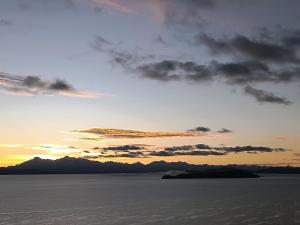 an island in the ocean under a sunset at Sol y Luna in Comunidad Yumani