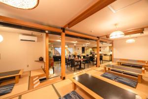 a room with a dining room with tables and chairs at Hirosaki Plaza Hotel in Hirosaki