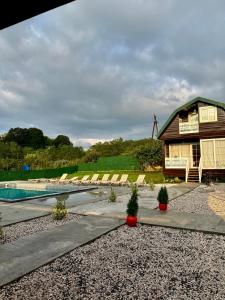 a house with a swimming pool next to a house at sweet village in Tsqaltubo