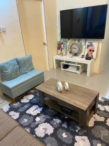 a living room with a coffee table and a flat screen tv at Winslow Place in Falmouth