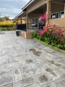 a patio in front of a house with pink flowers at Winslow Place in Falmouth