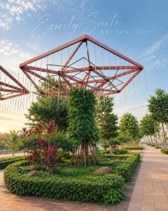 a large metal structure in a park with trees at EcoCity Suites BMT in Buôn Enao