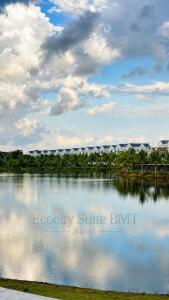 a large body of water with a building in the background at EcoCity Suites BMT in Buôn Enao