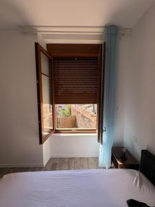 a bedroom with a bed and a window at Chambre avec salle de bain privé in Neuvic