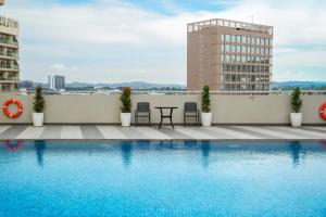 a swimming pool on the roof of a building at HARRIS Hotel & Suites Nagoya Batam in Nagoya