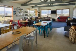 a living room with tables and chairs and a couch at Glentanner Park Centre in Glentanner