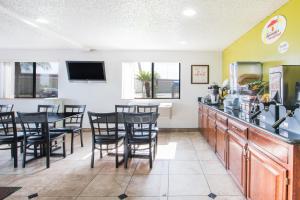 a dining room with a table and chairs at Super 8 by Wyndham Harlingen TX in Harlingen