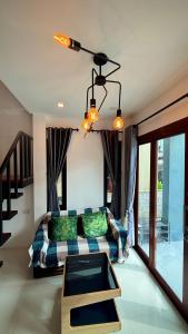a living room with a couch and a table at Happy House in Chaloklum in Chaloklum