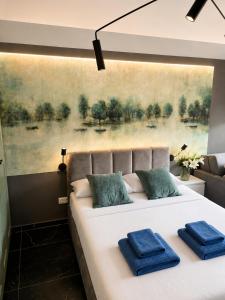 a bedroom with a large bed with blue pillows on it at Apartament Słowik Lux in Rowy