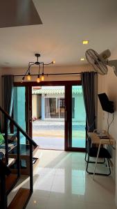 a living room with a view of a pool at Happy House in Chaloklum in Chaloklum