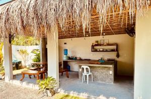 an outdoor kitchen with a table and chairs at Aulea Siargao in General Luna