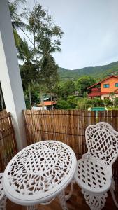 a white table and two chairs on a balcony at Happy House in Chaloklum in Chaloklum