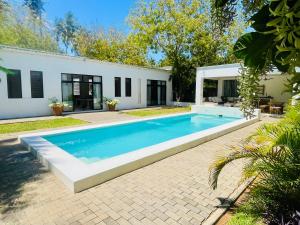 a swimming pool in the backyard of a house at Nyumba Nyekundu in Watamu